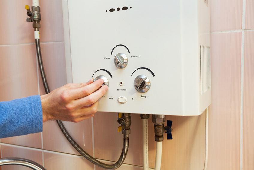 A Person Adjusting Water Heater Temperature